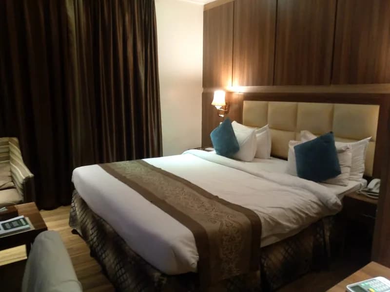 Bedroom photographed at Grand Pela Hotel & Suites; room category unconfirmed.